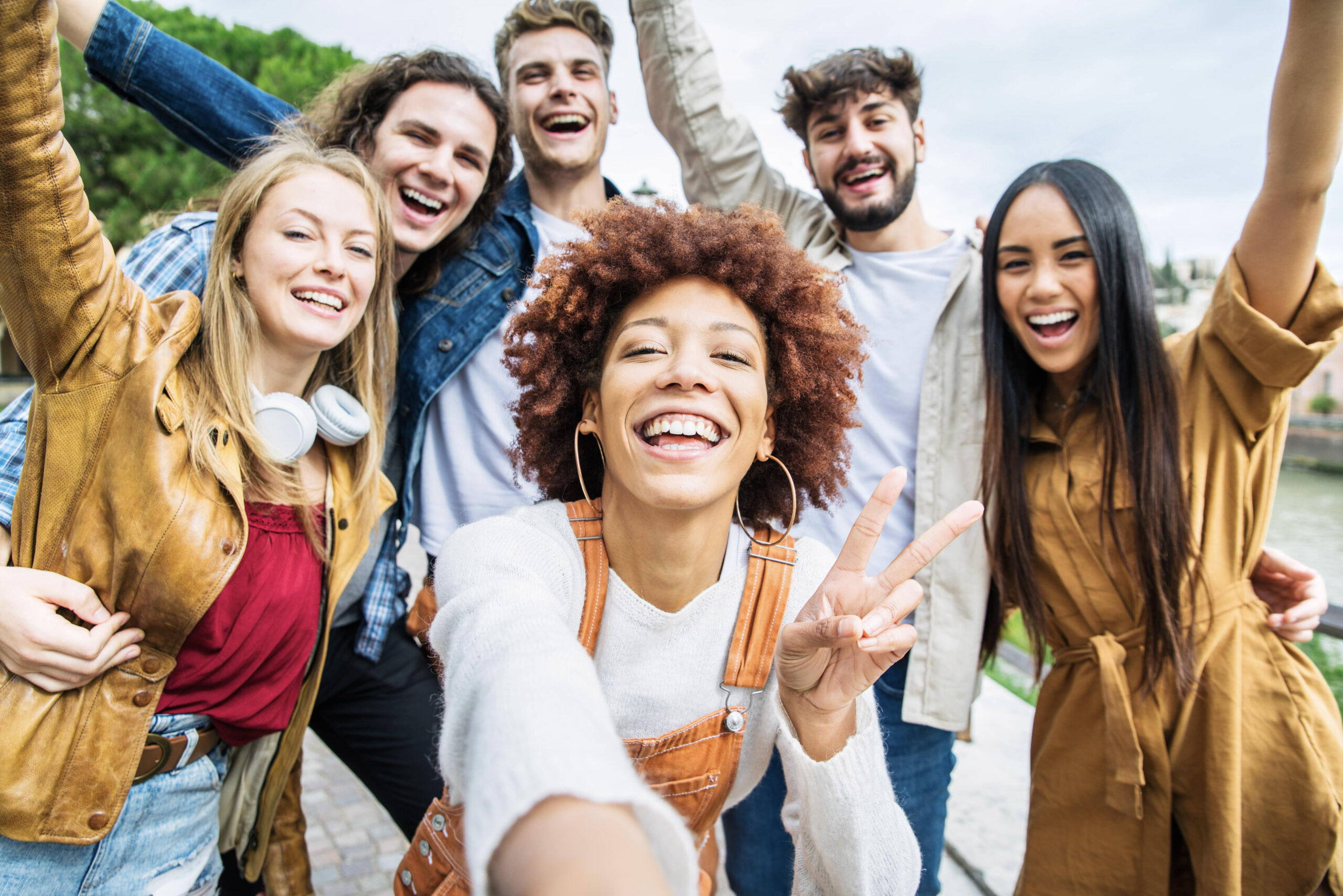 Group of happy friends taking selfie pic outside Happy different young people having fun walking in city center Youth lifestyle concept with guys and girls enjoying day out together