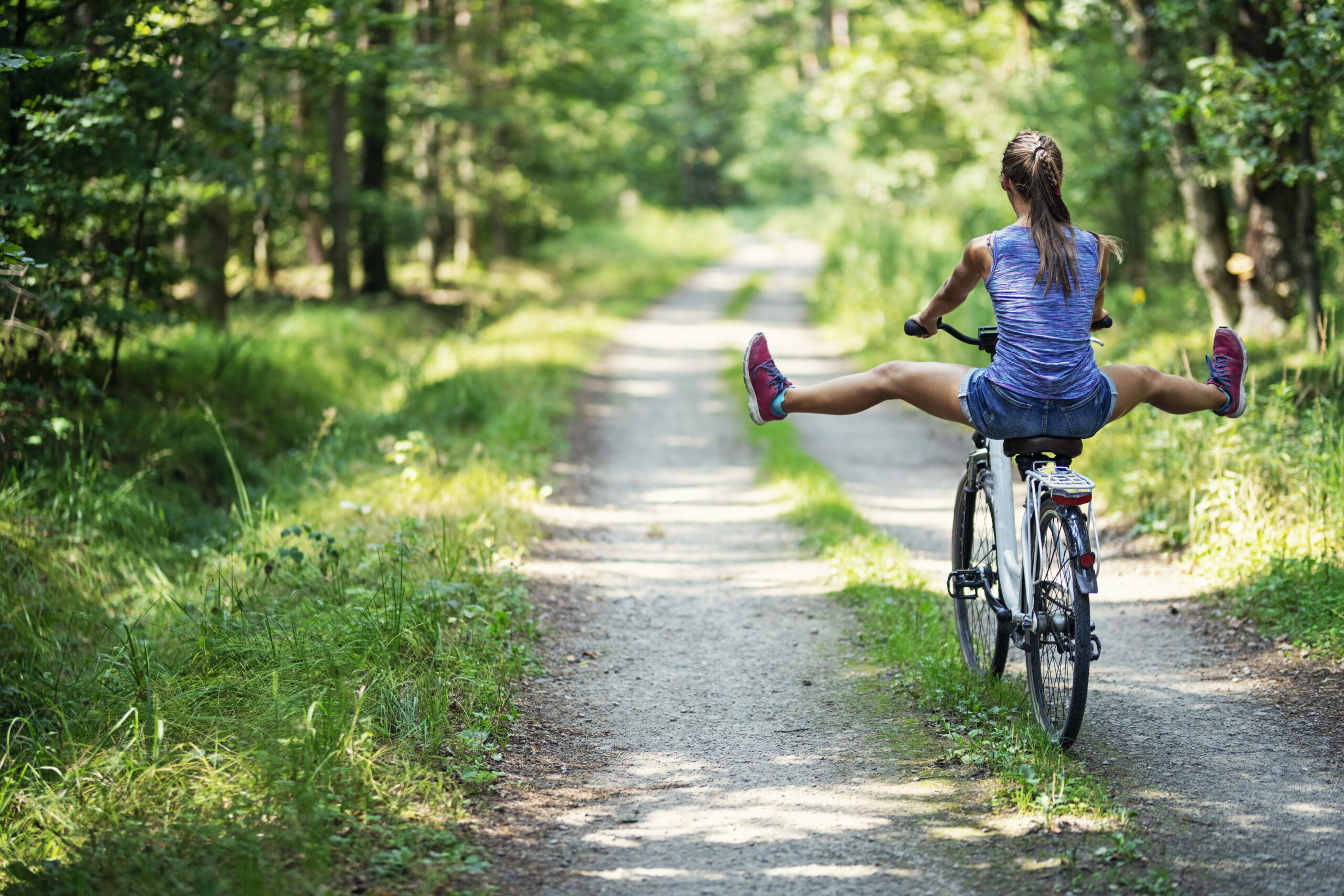 Teenage girl enjoying riding a bike