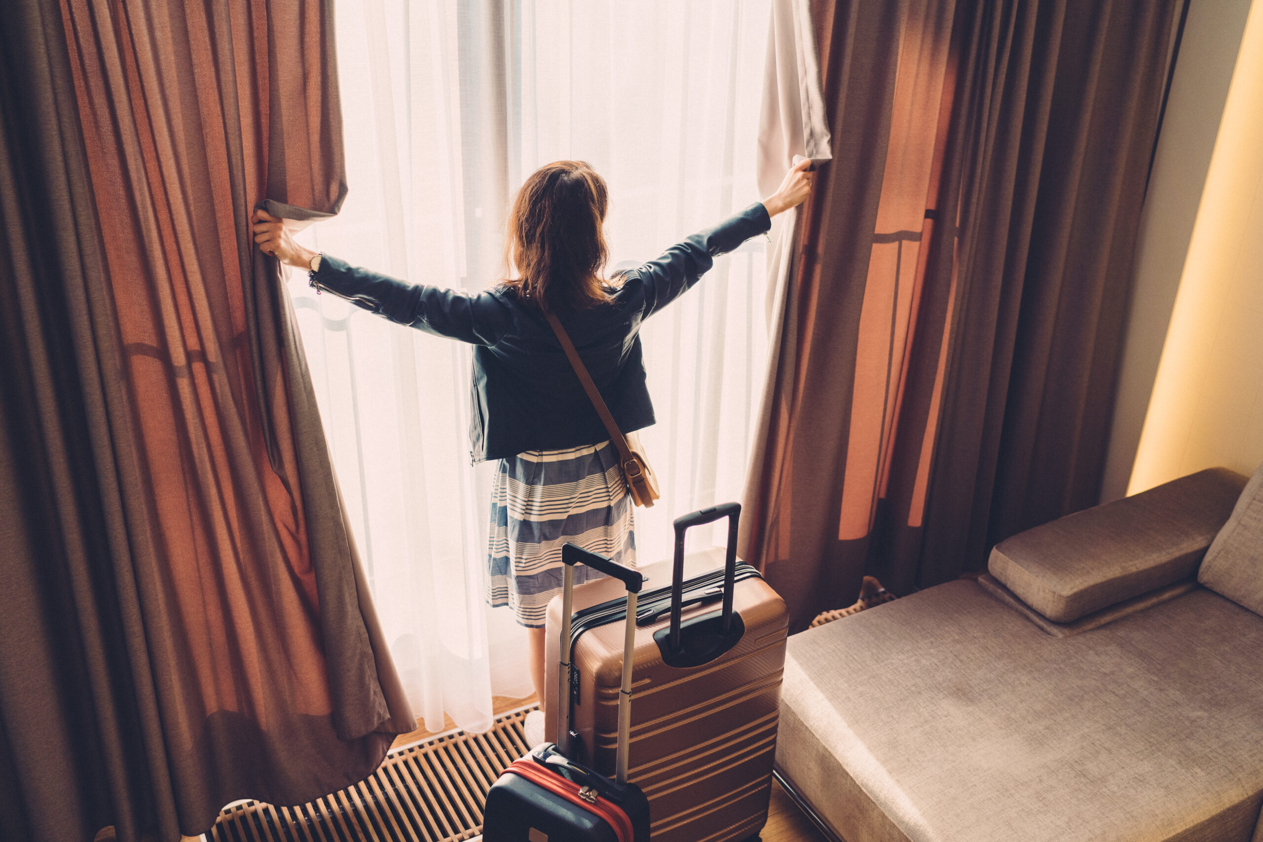 Tourist woman just arriving in the hotel room