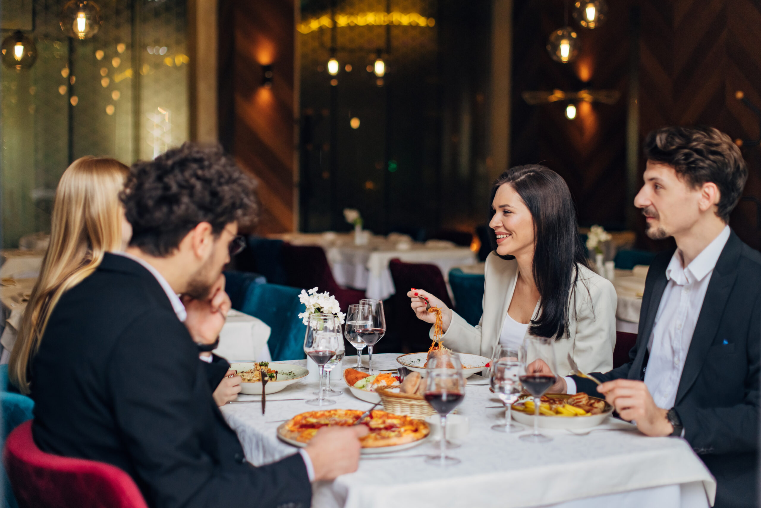 A small group of entrepreneurs having fun during a business lunch in a restaurant